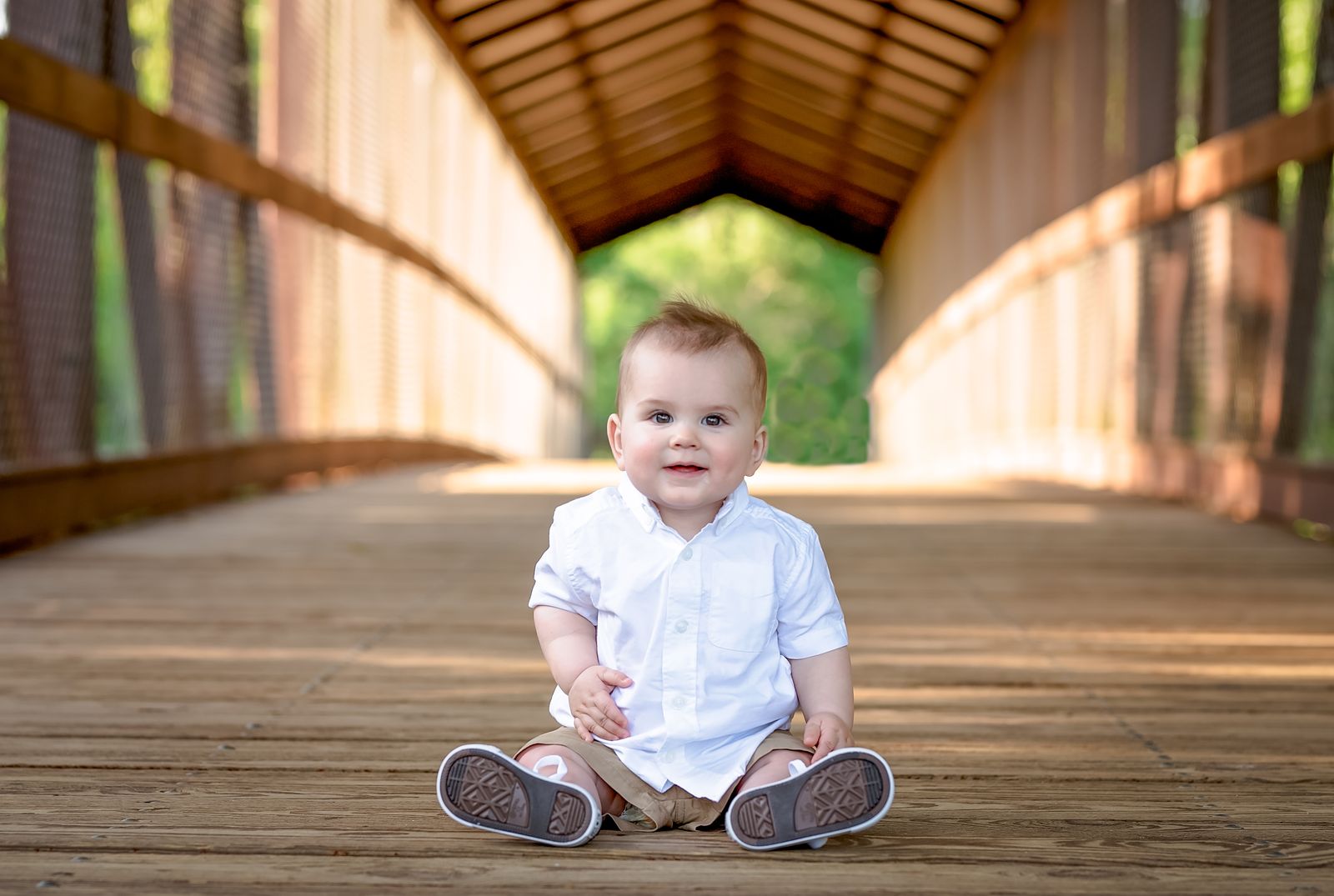 Baby sitting on the covered footbridge at the Alford Greenway