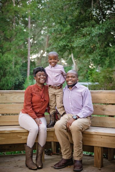 Family portrait on a wooden bench in the gardens at Dorothy B. Oven Park