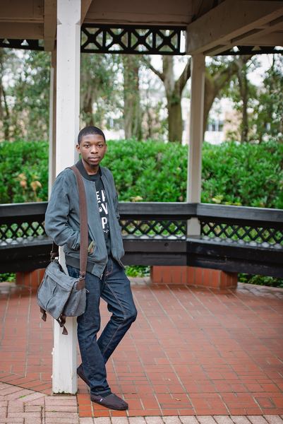 Teen leaning against a white post in the brick-floored gazebo at Dorothy B. Oven Park