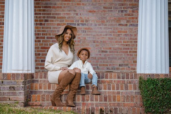 Mother and son sitting together on red brick steps at Pebble Hill Plantation near Tallahassee