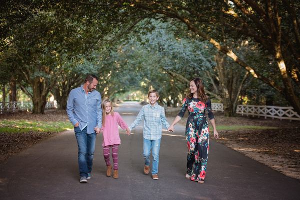 Family strolling down the long oak-lined avenue at Rose Hill