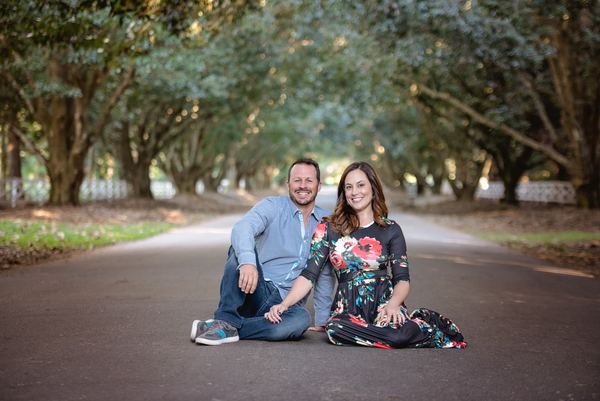 Couple sitting together on the oak-shaded drive at Rose Hill