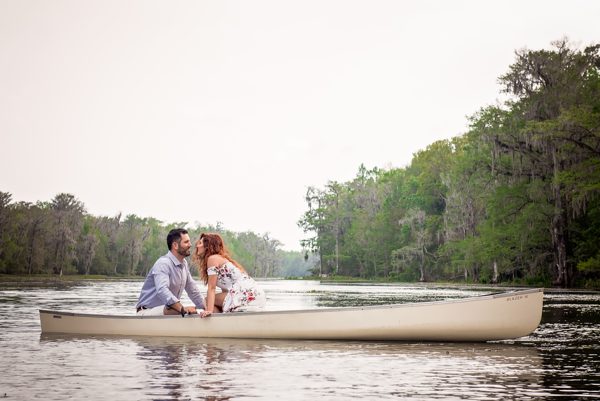 Couple sitting close together in a white canoe on the calm Wacissa River near Tallahassee